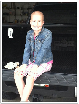 Lily sitting on a pickup truck